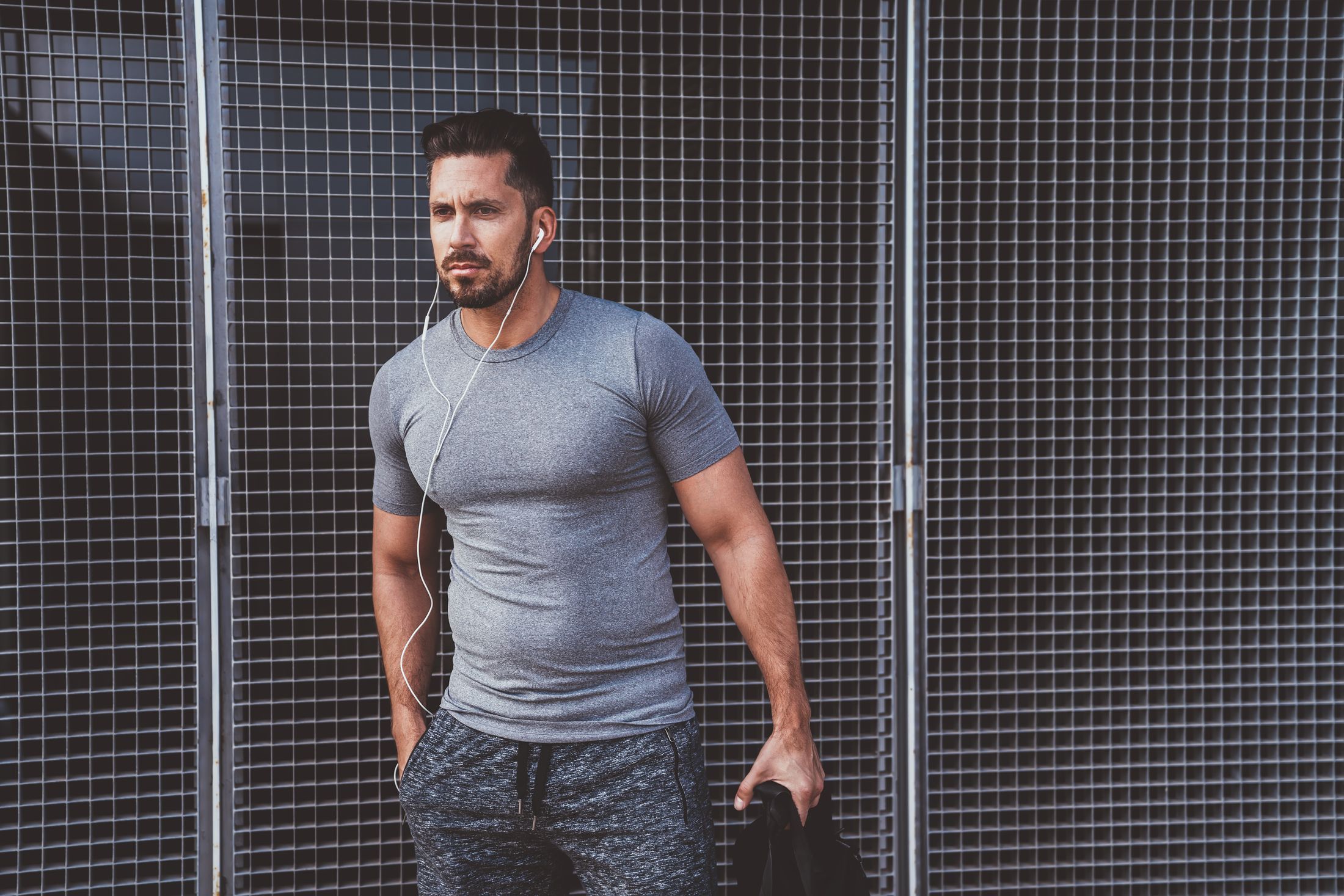 male model wearing gray workout clothing wearing headphones