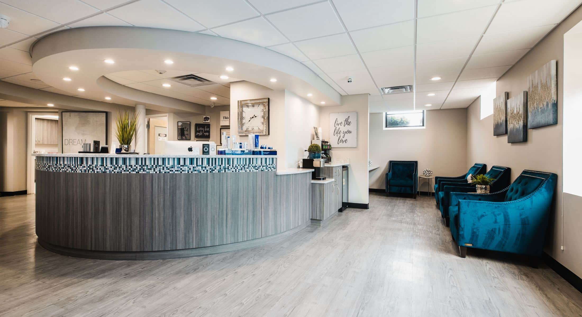 Modern reception area with teal seating.